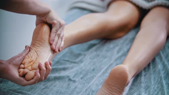 Massage - Massage Master Is Kneading Womans Feet with Both Hands