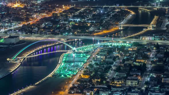 Dubai Water Canal with Footbridge Aerial Night Timelapse From Downtown Skyscrapers Rooftop