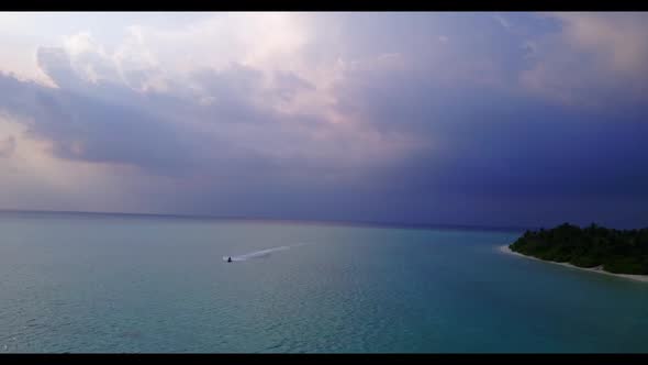 Aerial flying over panorama of luxury coastline beach adventure by clear ocean with white sand backg