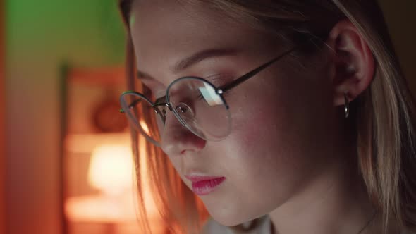 Closeup of Young Adult Women Wearing Reflective Eye Glasses Analyzing Cyber Security Code Data