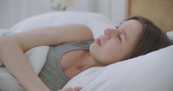 Woman Wakes Up Raise Stretches Hands in Bed Feels Healthy