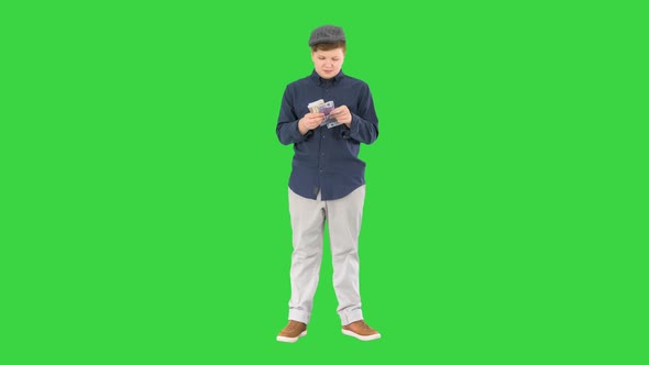 Rich Teenager Happy Boy Counting Euros on a Green Screen Chroma Key