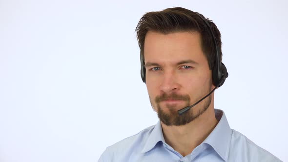 A Young Call Center Agent Shows a Thumb Down To the Camera and Shakes His Head - White Screen