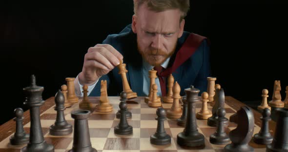 Portrait of Hesitant Young Businessman Doubting What Move To Make in Chess