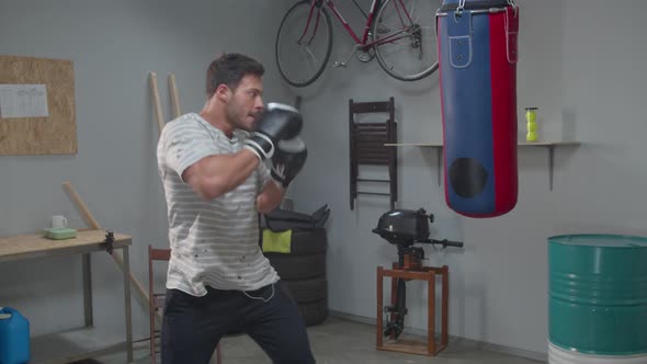 Man Professionally Hits Boxing Punching Bag, Slow Motion