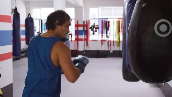 Caucasian man working out in boxing gym