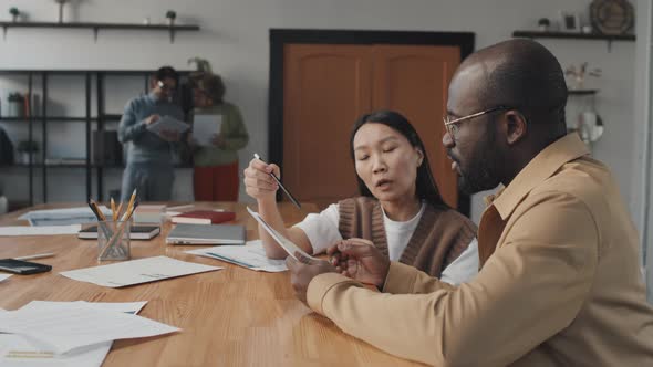 Man and Woman Talking in Conference Room