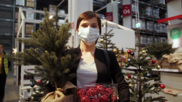 Portrait of happy customer with christmas tree and decorations. Concept Christmas sales season.