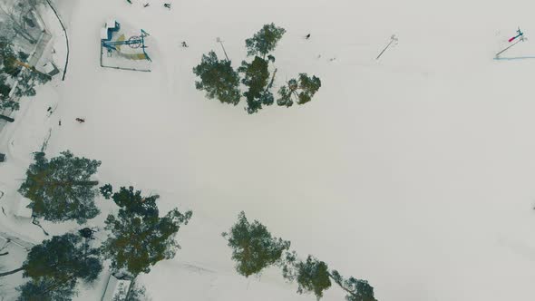 Ski Resort with Lift and People on Snowy Mountain Upper View