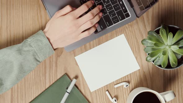 Mockup a Blank Paper Lies on the Desktop of a Young Woman