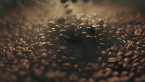 Fragrant Roasted Coffee Beans Are Splashing, Aromatic Smoke and Brown Background in Slow Motion