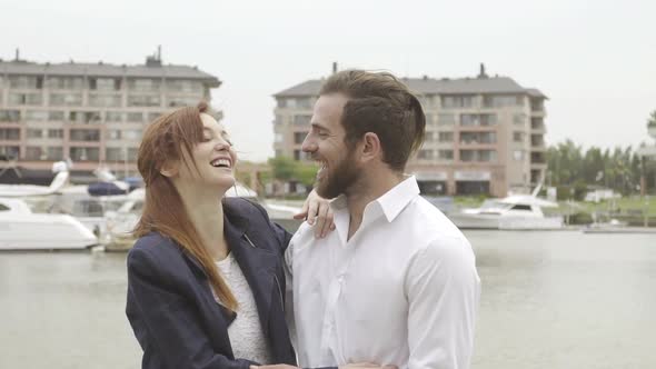 Happy couple laughing and embracing outdoors