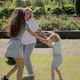 Grandmother with Two Granddaughters Spinning in the Garden - VideoHive Item for Sale