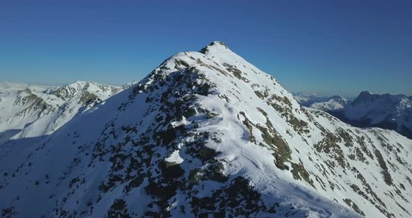 Aerial drone view of snow covered mountains in the winter