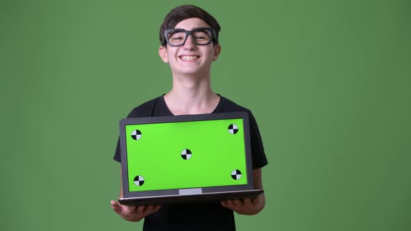 Young Handsome Iranian Teenage Boy Against Green Background