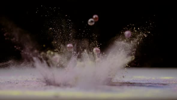 Water gel balls falling in colorful dust, Ultra Slow Motion alt