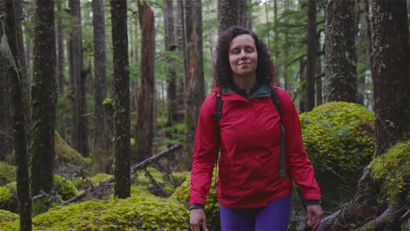 Girl Hiking on a Path in the Rain Forest During a Rainy Winter Season