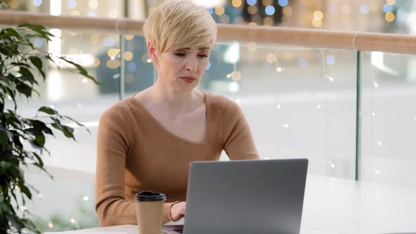 Caucasian Adult Mature Stressed Woman Working on Laptop Worry System Virus Looking at Laptop