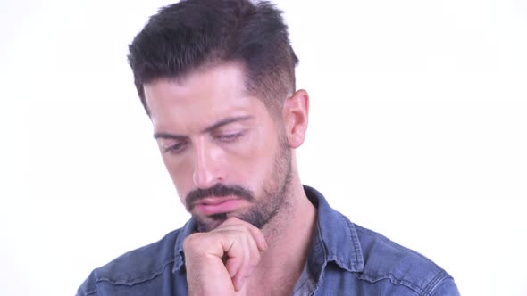 Face of Stressed Young Bearded Hipster Man Thinking and Looking Down