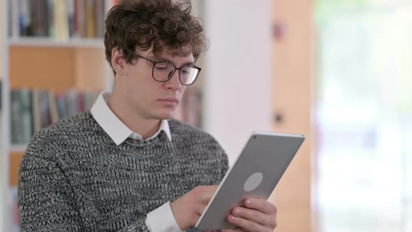 Portrait of Young Man Using Digital Tablet