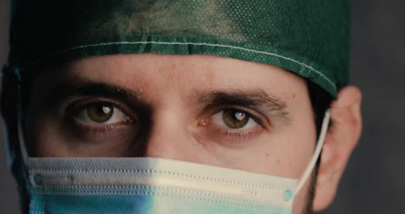 Eyes of a male doctor smiling under the Mask