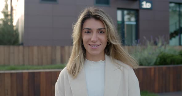 Portrait of Attractive Young Woman with Blond Hair Looking and Posing To Camera. Crop View of