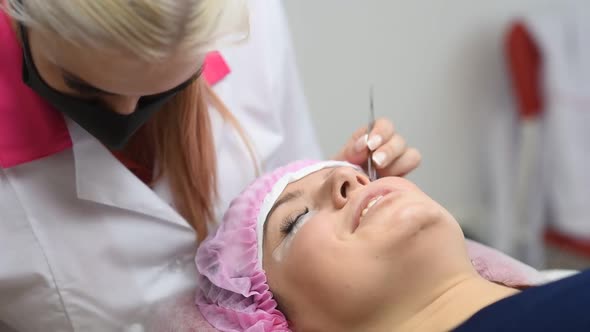 Professional Beautician Undergoing Eyelash Extension Procedure