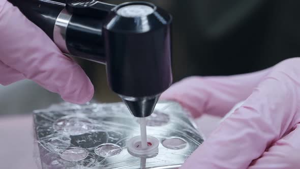 Closeup of the Hand of a Permanent Makeup Master Prepares Materials Tools for Lip Micropigmentation