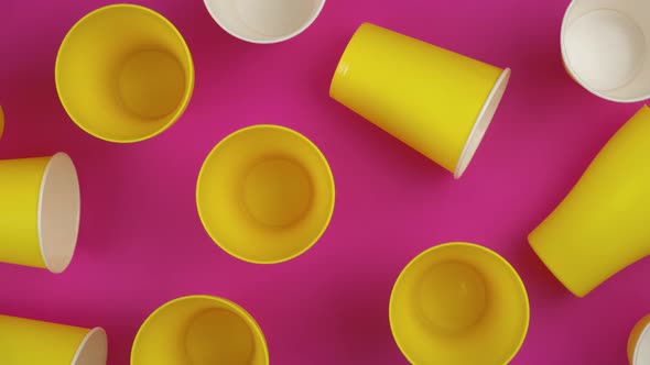 Flat Lay Top View of a Yellow Cups with Pink Background