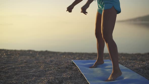 Beautiful Woman Trains on the Beach. Sea, Sunrise, Beach, Workout, Slow Motion