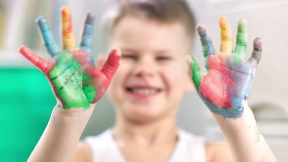 A Closeup Video of Child Hands Covered in Paint