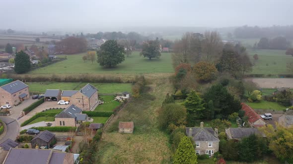 Aerial footage on a very foggy day of the village of Wetherby in Leeds West Yorkshire in the UK 