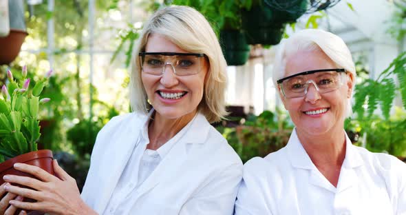 Female scientists smiling in greenhouse