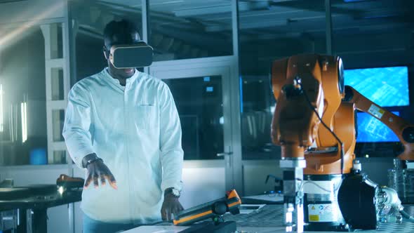 African Ethnicity Engineer in VRglasses Is Navigating a Robotic Mechanism