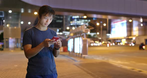 Man use of mobile phone at night