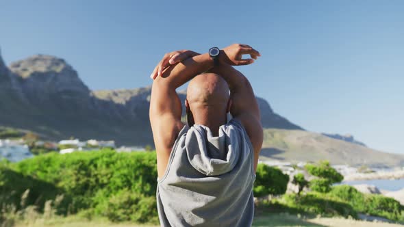 Senior african american man exercising stretching listening to music