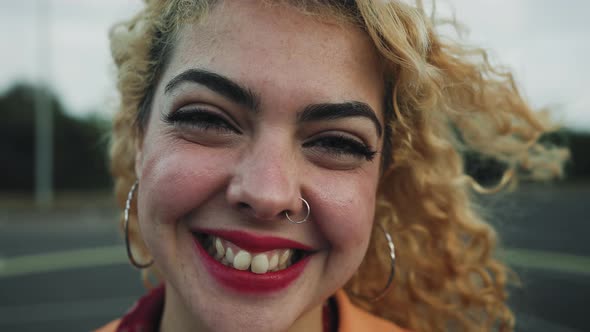 Happy young girl smiling in front of camera outdoor