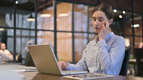 Woman with Headache Working on Laptop