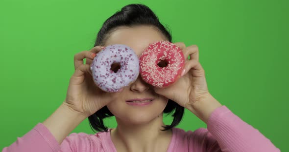 Happy Beautiful Young Girl Posing and Having Fun with Donuts. Chroma Key