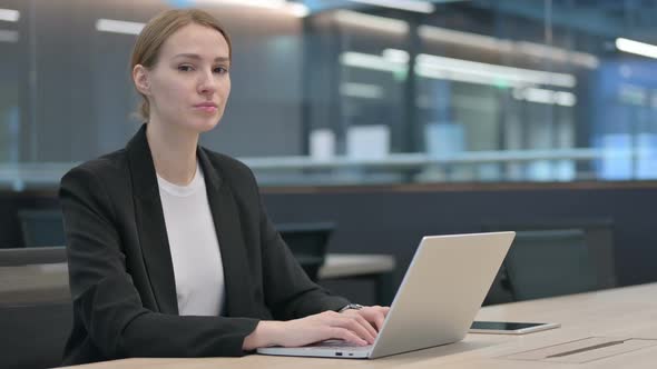 Businesswoman with Laptop Shaking Head As No Sign