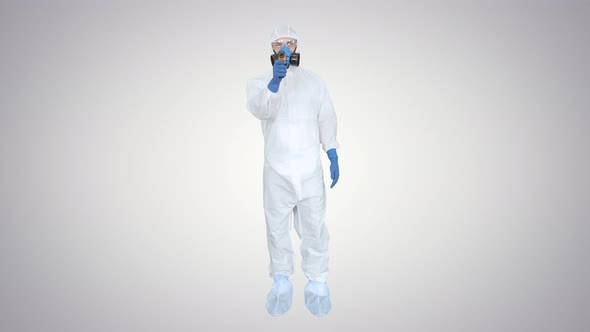 Doctor in Protective Suit Checking Your Temperature on Gradient Background.