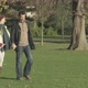 Couple walking through park holding hands - VideoHive Item for Sale