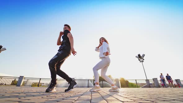 Dancing couple near fountain. Happy cheerful young loving couples dancing outdoors