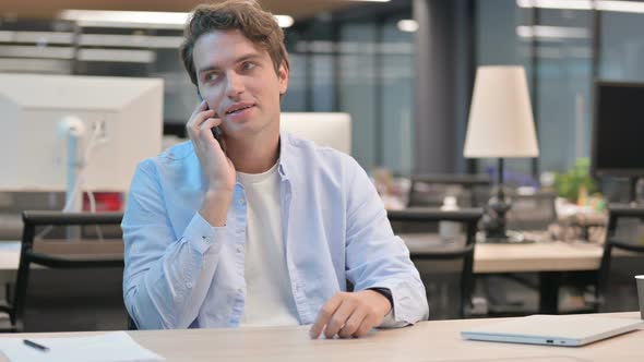 Man Talking on Smartphone in Office