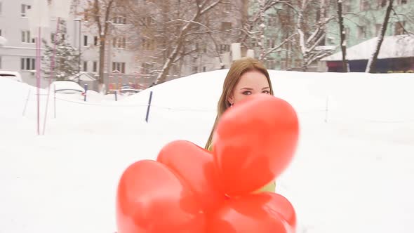 Slowmotion Picture of a Romantic Young Woman Enjoying Balloons