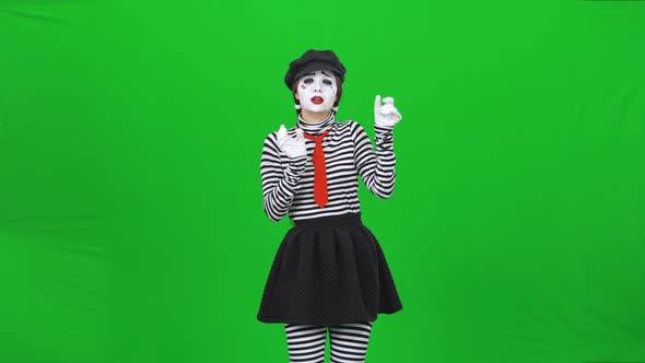 Mime Girl Listening To the Music Through Headphones. Chroma Key.