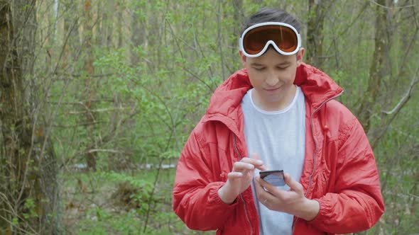 Happy Man in Red Using a Phone