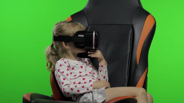 Child Girl Using VR Helmet To Play Simulation Game App. Watch Virtual Reality 3d Video. Chroma Key