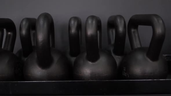 Close up footage of kettlebell weights in various weights in a gym