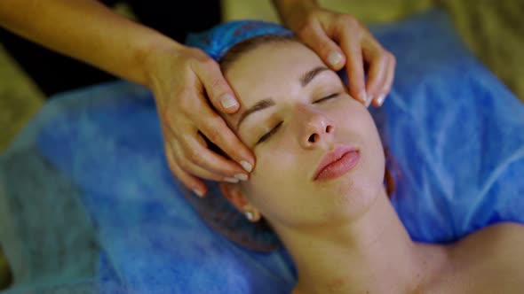 Relaxing Beautiful Woman Having a Massage on a Face